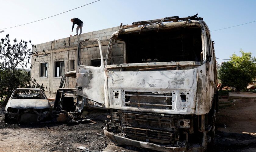 A Palestinian man inspects the damage after Israeli settlers attacked a village in the Israeli-occupied West Bank in April. Pic: Reuters