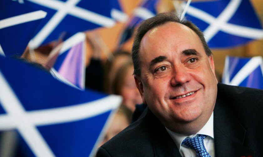 Scotland's then first minister Alex Salmond smiles surrounded by national flags in 2007. Pic: Reuters