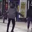 Terrifying moment two masked men 'with machetes' go head to head on a busy London high street - as witnesses cry for them to 'stop'