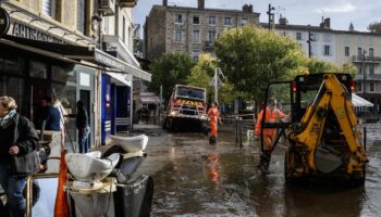 Workers clear mud from the street, in Annonay, central France, on October 18, 2024, the day after the city was stuck by floods.Des agents nettoyent les rues d'Annonay, en Ardèche, au lendemain des inondations qui ont frappé la ville, le 18 octobre 2024