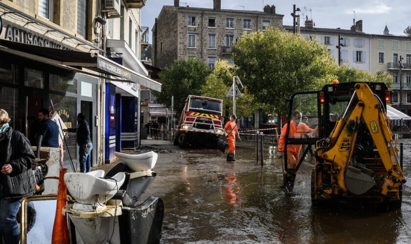 Workers clear mud from the street, in Annonay, central France, on October 18, 2024, the day after the city was stuck by floods.Des agents nettoyent les rues d'Annonay, en Ardèche, au lendemain des inondations qui ont frappé la ville, le 18 octobre 2024