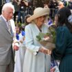 Children greet King Charles III and Queen Camilla outside a Sydney church