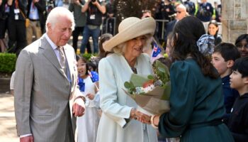 Children greet King Charles III and Queen Camilla outside a Sydney church