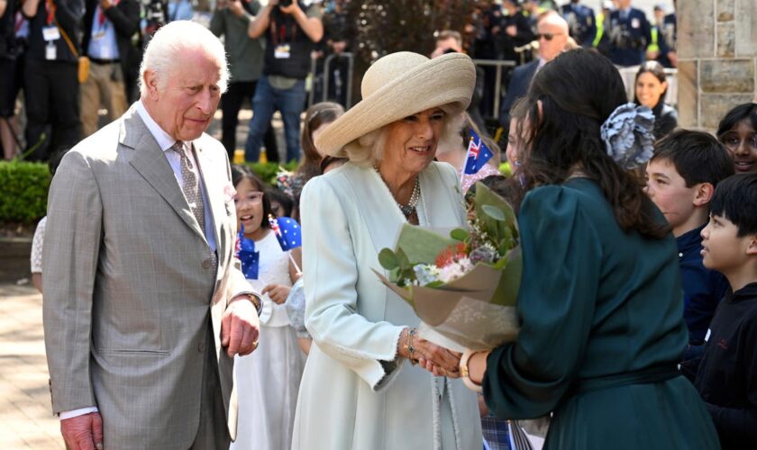 Children greet King Charles III and Queen Camilla outside a Sydney church