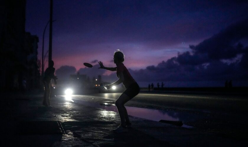 With little else to do during the blackout, residents played frisbee in Havana. Pic: AP