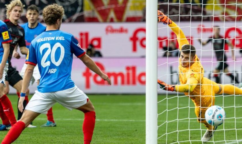 Union Berlins Tom Rothe (2. v l) trifft zum 0:2 gegen Kiels Torwart Timon Weiner (r). Foto: Axel Heimken/dpa