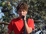 Guess the Hollywood offspring! Son of celebrity chef and actress shows off his singing and guitar skills as he performs at LA beach festival