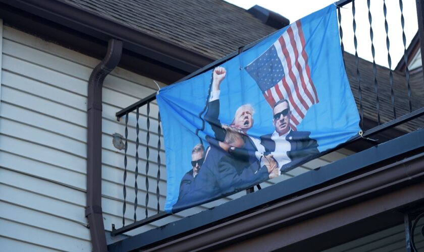 A flag depicting the attempted assassination of Trump at a Michigan home