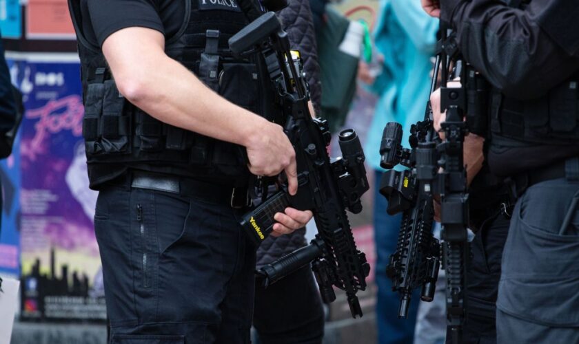 leeds, United Kingdom – May 05, 2019: Horizontal shot of armed police patrolling tour de yorkshire crowd to keep everyone safe