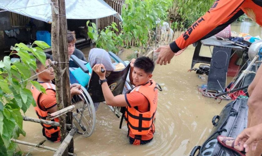 Philippine Coast Guard personnel rescue residents in Bicol, Philippines. Pic: Reuters