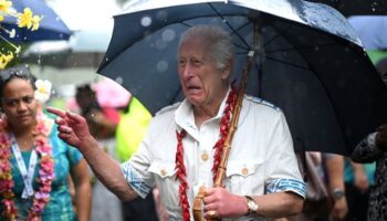 King Charles ditches suit for island life while battling torrential rain