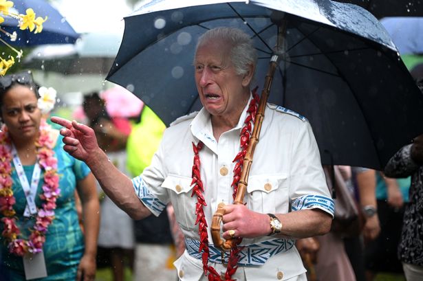 King Charles ditches suit for island life while battling torrential rain