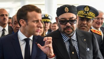 French President Emmanuel Macron (C-L) gestures as he speaks with Morocco's King Mohamed VI (C-R) upon their arrival at Rabat Agdal train station for the inauguration of a high-speed railway line on November 15, 2018. French President Emmanuel Macron visits Morocco to take part in the inauguration of a high-speed railway line that boasts the fastest journey times in Africa or the Arab world. (Photo by FADEL SENNA / AFP)