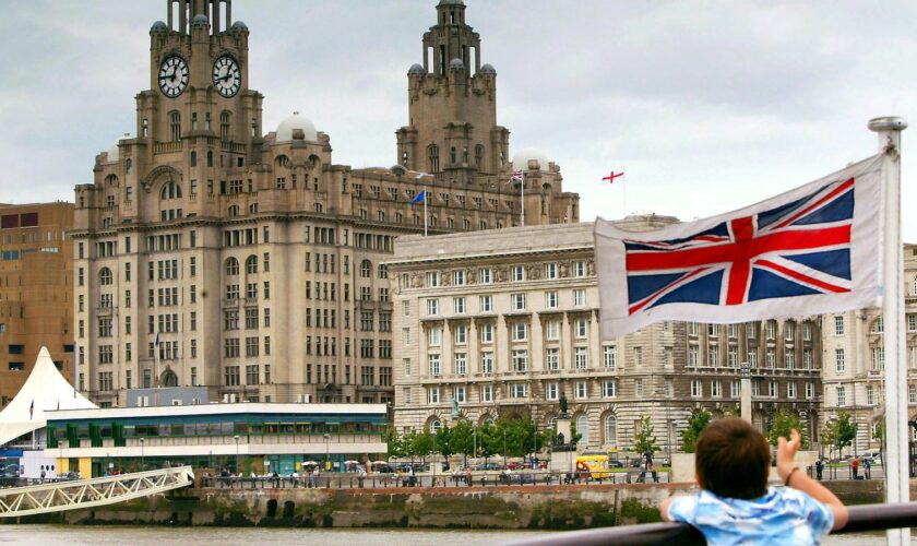 A young passenger looks at the Liverpool skyline as the Mersey Ferry comes into dock. Pic: Reuters