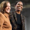 Former first lady Michelle Obama, right, and Democratic presidential nominee Vice President Kamala Harris address the crowd in the overflow space of a campaign rally at the Wings Event Center in Kalamazoo, Mich. (AP Photo/Jacquelyn Martin)