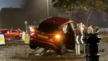 Car left dangling from traffic signs on roundabout after horror crash