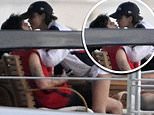 Cruz Beckham, 19, packs on the PDA with girlfriend Jackie Apostel, 29, as she displays her surgery scar in a backless top during a family day out on a superyacht in Miami