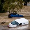 Cars are swept away by the water, after floods preceded by heavy rains caused the river to overflow its banks in the town of Alora, Malaga, Spain, Tuesday, Oct. 29, 2024. (AP Photo/Gregorio Marrero)