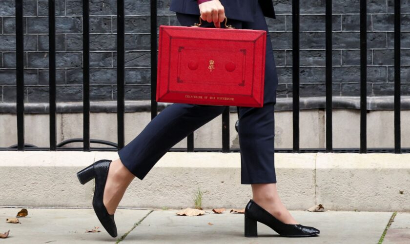 Britain's Chancellor of the Exchequer Rachel Reeves walks with the red budget box outside her office on Downing Street in London, Britain October 30, 2024. REUTERS/Mina Kim