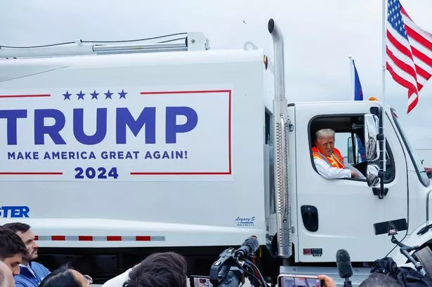 Donald Trump mocks Joe Biden by riding a rubbish truck to his Wisconsin rally