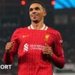 Trent Alexander-Arnold smiling while running on the pitch