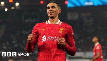 Trent Alexander-Arnold smiling while running on the pitch