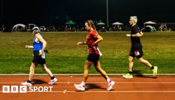 Competitors run through the night in the Sri Chinmoy 24hr Track Race in Battersea Park