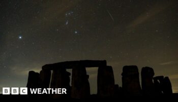 A meteor streaks in the skies above Stonehenge