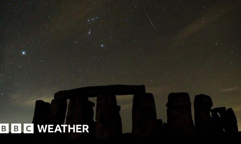 A meteor streaks in the skies above Stonehenge