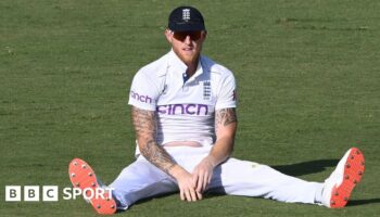 Ben Stokes sits on the pitch