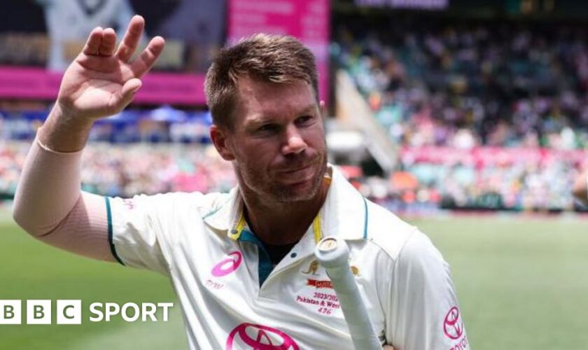 Australia opener David Warner waves as he walks off the pitch