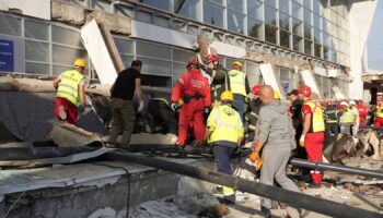 Rescue service workers at the scene of the roof collapse. Pic: AP