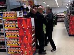 Moment Asda 'security guard punches and slaps customer as he is held down by two workers'