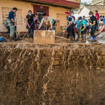 Volunteers and residents cleanup the mud four days after flash floods swept away everything in their path in Paiporta, outskirts of Valencia, Spain, Saturday, Nov. 2, 2024.(AP Photo/Angel Garcia)