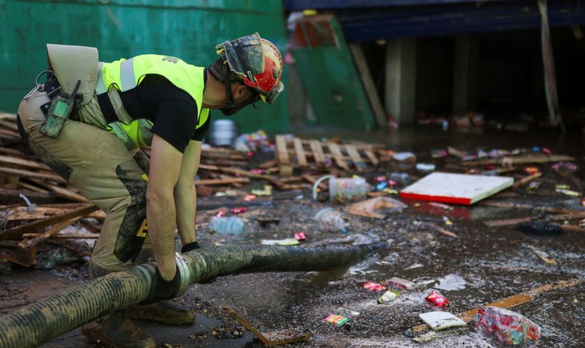 An emergency works on removing water from one of the exits of the car park. Pic: Reuters