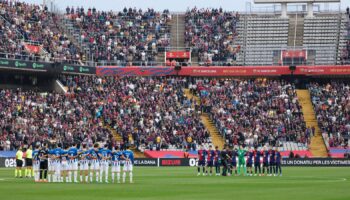 Players observe a minute's silence for the flood victims ahead of Barcelona v Espanyol on Sunday. Pic: AP