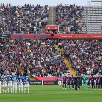 Players observe a minute's silence for the flood victims ahead of Barcelona v Espanyol on Sunday. Pic: AP