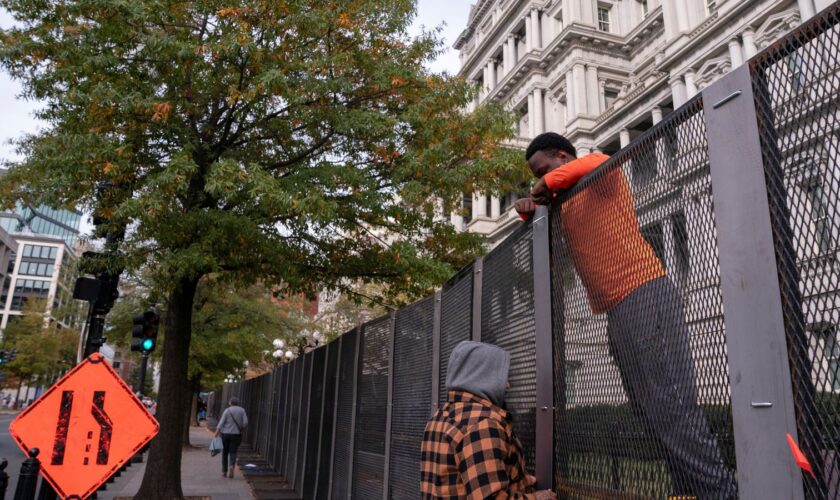 Workers put up security fencing near the White House on Monday. Pic: Reuters