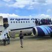 Moment flames shoot from the engine of a Boeing jet before take-off forcing terrified passengers to jump from emergency exits