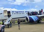 Moment flames shoot from the engine of a Boeing jet before take-off forcing terrified passengers to jump from emergency exits