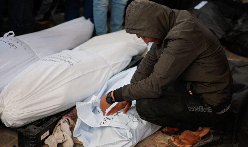 A man reacts next to the bodies of Palestinians killed in Israeli strikes in February. Pic: Reuters