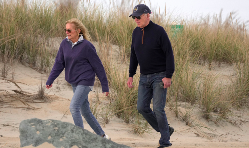 Biden appears to struggle while walking on beach with first lady