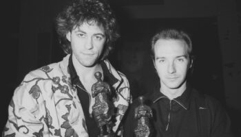 Midge Ure (R), 31, of the rock group Ultravox, with Bob Geldof at the Ivor Novello Awards for 1984 at the Grosvenor House Hotel, London. The pair won a joint award for the Band Aid single 'Do They Know It's Christmas?"