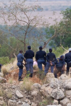 Body pulled from mine after police cut off supplies to illegal miners pinned underground