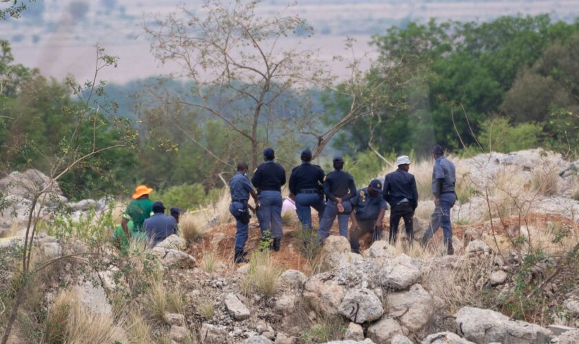 Body pulled from mine after police cut off supplies to illegal miners pinned underground