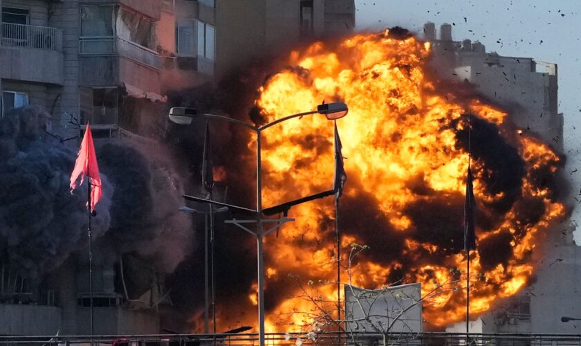 Smoke and flames erupt from a building hit in an Israeli airstrike in Tayouneh, Beirut, Lebanon, Friday, Nov. 15, 2024. (AP Photo/Hassan Ammar)