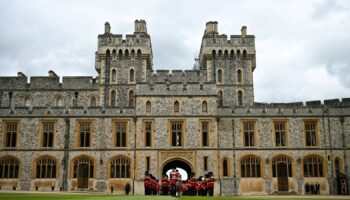 The Band of the Irish Guards, led by the Irish Guards' Regimental Mascot, an Irish wolfhound named Seamus (Turlough Mor), march into Windsor Castle's Quadrangle through the George IV Gate during a ceremony where Britain's King Charles III presents New Colours to No 9 and No 12 Company The Irish Guards at Windsor Castle, west of London, on June 10, 2024. The new Colours will be those trooped in the Trooping of the Colour at His Majesty's official Birthday Parade in London on Saturday June 15, 202