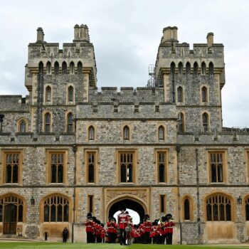 The Band of the Irish Guards, led by the Irish Guards' Regimental Mascot, an Irish wolfhound named Seamus (Turlough Mor), march into Windsor Castle's Quadrangle through the George IV Gate during a ceremony where Britain's King Charles III presents New Colours to No 9 and No 12 Company The Irish Guards at Windsor Castle, west of London, on June 10, 2024. The new Colours will be those trooped in the Trooping of the Colour at His Majesty's official Birthday Parade in London on Saturday June 15, 202