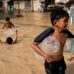 Children play along a flooded street following super typhoon Man-Yi, in Cabanatuan, Nueva Ecija, Philippines, November 18, 2024. REUTERS/Lisa Marie David TPX IMAGES OF THE DAY