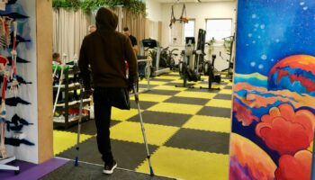 A man without his leg looks inside of Tytanova Rehab, Kyiv